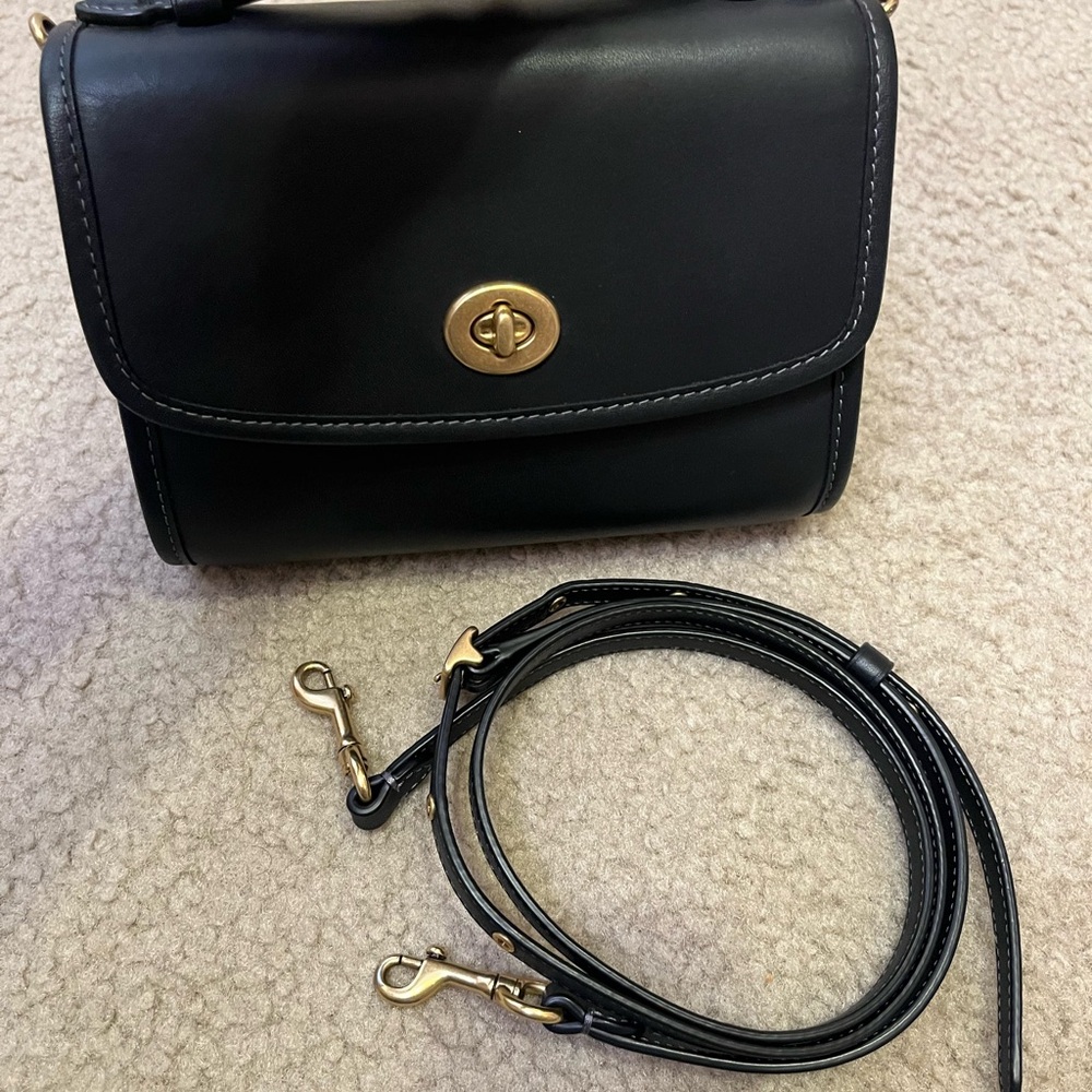 Coach Kip Turnlock Crossbody in black with brass hardware.